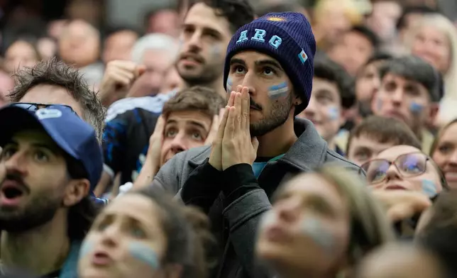 Fans watch the World Cup semifinal soccer match between England and Argentina outside a bar in Buenos Aires, Argentina, Wednesday, July 15, 2026. (AP Photo/Natacha Pisarenko)