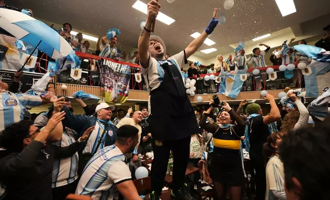 Fans react after watching the World Cup quarterfinal soccer match between Argentina and Switzerland at a restaurant in Buenos Aires, Argentina, Sunday, July 12, 2026. (AP Photo/Rodrigo Abd)