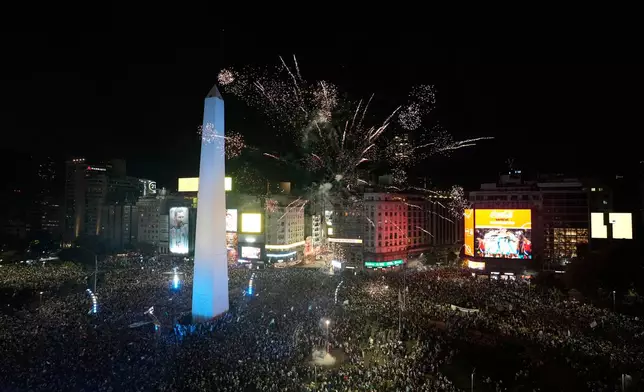 Fans celebrate Argentina's victory over England in a World Cup semifinal soccer match around the Obelisk in downtown Buenos Aires, Argentina, Wednesday, July 15, 2026. (AP Photo/Natacha Pisarenko)