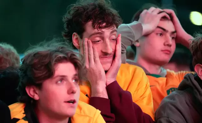 Dejected fans watch on large screens the World Cup round of 32 soccer match between Australia and Egypt, in Sydney, Saturday, July 4, 2026. (AP Photo/Rick Rycroft)