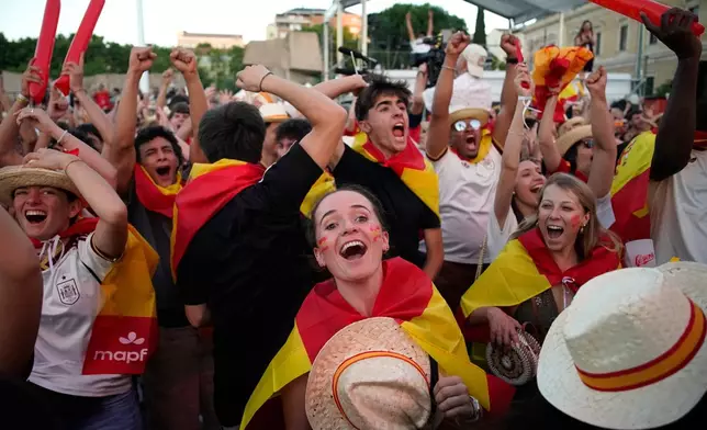 Spanish fans gathered in central Madrid celebrate Mikel Oyarzabal's goal during the World Cup round of 32 soccer match between Spain and Austria in Inglewood, California, near Los Angeles, Thursday, July 2, 2026. (AP Photo/Andrea Comas)