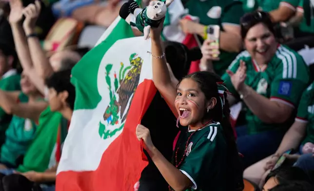 Mexico fans cheer at Shell Energy Stadium, home of the MLS soccer club Houston Dynamo, as they watch a live broadcast in Houston, of a World Cup soccer round of 32 match between Mexico and Ecuador, Tuesday, June 30, 2026. (AP Photo/Ashley Landis)