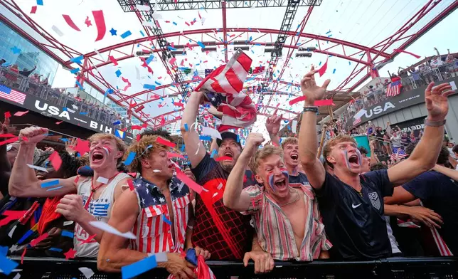 Fans cheer during a watch party for a World Cup soccer match between the United States and Bosnia at the KC Live! entertainment district Wednesday, July 1, 2026, in Kansas City, Mo. (AP Photo/Charlie Riedel)