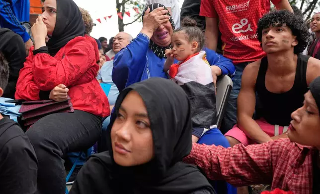 Egyptian fans, including Faten Moussa, center in blue, react towards the end of a World Cup soccer game against Argentina, in New York, Tuesday, July 7, 2026. (AP Photo/Seth Wenig)