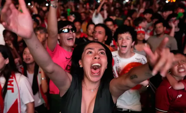 Fans watching on a big screen in Lisbon, Portugal, react after VAR disallowed a second goal by Croatia in the last minute of the World Cup round of 32 soccer match between Portugal and Croatia, Friday, July 3, 2026 . (AP Photo/Armando Franca)