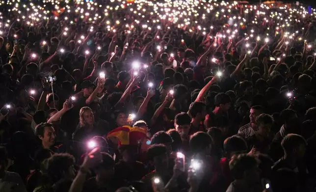 Spanish fans cheer for their team while watching the World Cup final soccer match between Spain and Argentina on giant screens in central Madrid, Sunday, July 19, 2026. The match is being played in East Rutherford, N.J., near New York. (AP Photo/Manu Fernandez)