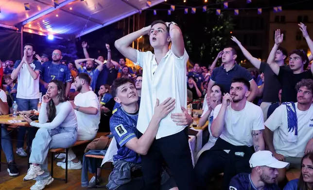 Bosnian national team soccer fans react as they watch a broadcast of the FIFA World Cup round of 32 soccer match between the United States and Bosnia, at a fan zone in Sarajevo, Bosnia, Thursday, July 2, 2026. (AP Photo/Armin Durgut)