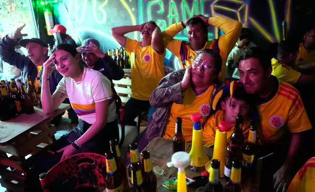 Fans watch the World Cup round of 16 soccer match between Colombia and Switzerland in a bar in Bogota, Colombia, Tuesday, July 7, 2026. (AP Photo/Fernando Vergara)