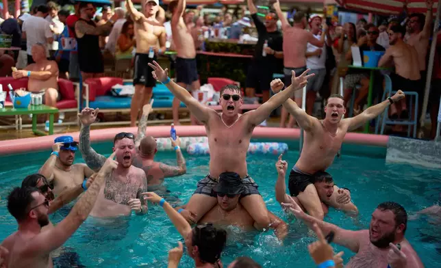 England soccer fans sing along with music as they gather to support their team on the eve of their quarterfinal World Cup soccer match against Norway, Friday, July 10, 2026, at The Clevelander on Ocean Drive in Miami Beach, Fla. (AP Photo/Rebecca Blackwell)
