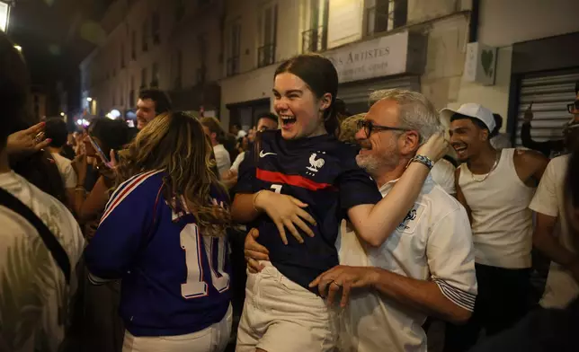 French fans react as they watch a broadcast of the World Cup quarterfinal soccer match between France and Morocco, Thursday, July 9, 2026, in Paris. (AP Photo/Thomas Padilla)