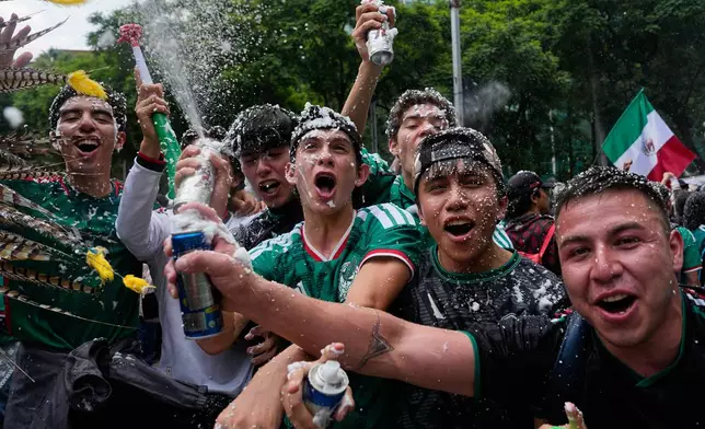 Soccer fans get revved up at a watch party on Reforma Ave., near the Angel of Independence monument, for the World Cup soccer match between Mexico and Ecuador, in Mexico City, Tuesday, June 30, 2026. (AP Photo/Marco Ugarte)