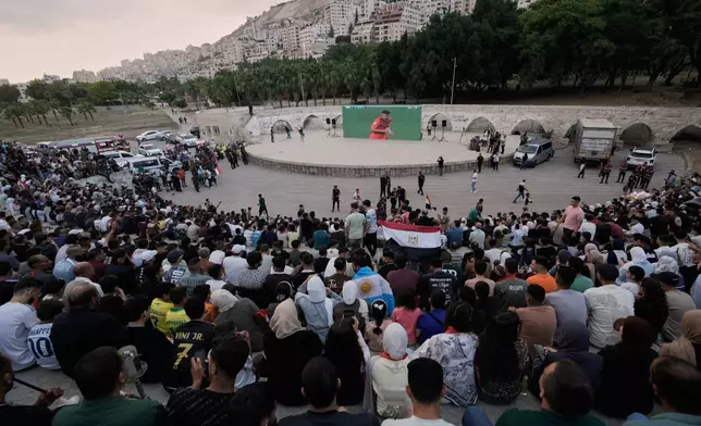 Palestinians watch a live broadcast of the World Cup round of 16 soccer match between Argentina and Egypt in the West Bank city of Nablus, Tuesday, July 7, 2026. (AP Photo/Majdi Mohammed)