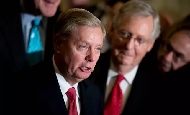 FILE - Sen. Lindsey Graham, R-S.C., flanked by Senate Majority Leader Mitch McConnell, R-Ky., right, speaks to reporters at the Capitol in Washington, Sept. 26, 2017. (AP Photo/Andrew Harnik, File)