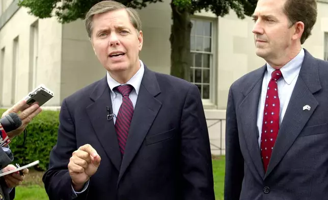 FILE - Sen. Lindsey Graham, R-S.C., speaks to the press about the appointment of federal judges during a news conference with Senate candidate Rep. Jim DeMint, right, at the Federal courthouse in Greenville, S.C., Oct. 21, 2004. (AP Photo/Mary Ann Chastain, File)