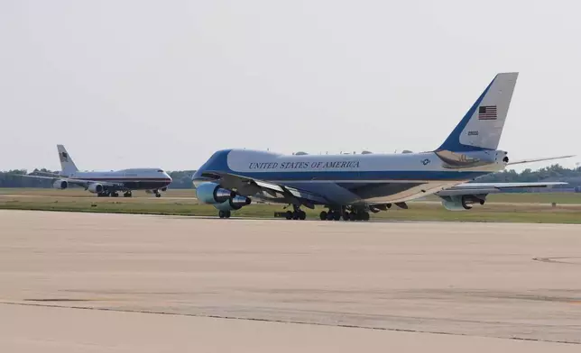 The newly designated Air Force One, left, with president Donald Trump on board, takes off on the runway as the old version of the plane is in the foreground, at Joint Base Andrews, Md., Wednesday, July 1, 2026 (AP Photo/Luis M. Alvarez)