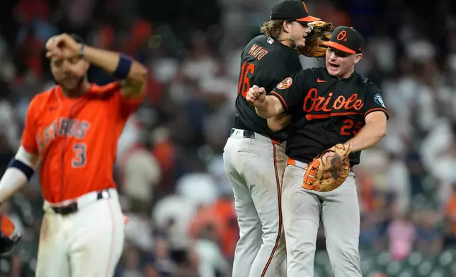 Baltimore Orioles' Coby Mayo, left, and Pete Alonso, right, celebrate their win over the Houston Astros after a baseball game, Friday, July 17, 2026, in Houston. (AP Photo/Karen Warren)
