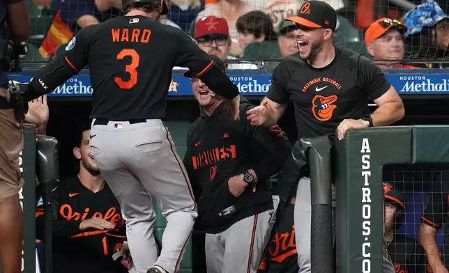 Baltimore Orioles' Taylor Ward (3) celebrates his go-ahead, two-run home run with teammates during the eighth inning of a baseball game against the Houston Astros, Friday, July 17, 2026, in Houston. (AP Photo/Karen Warren)