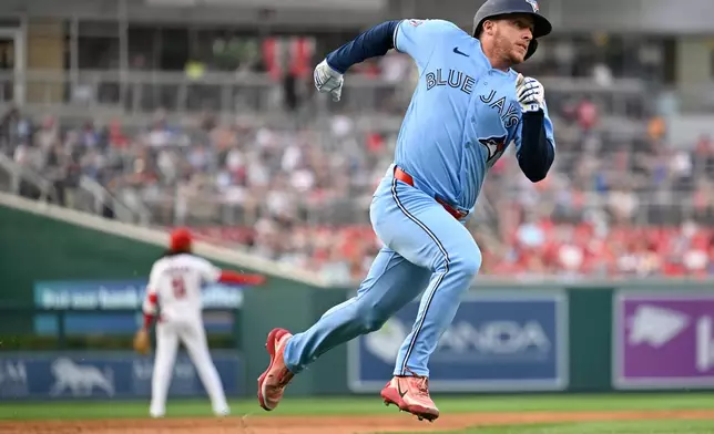 Toronto Blue Jays' Myles Straw heads home to score on an RBI double by Ernie Clement during the third inning of a baseball game against the Washington Nationals, Monday, July 27, 2026, in Washington. (AP Photo/John McDonnell)