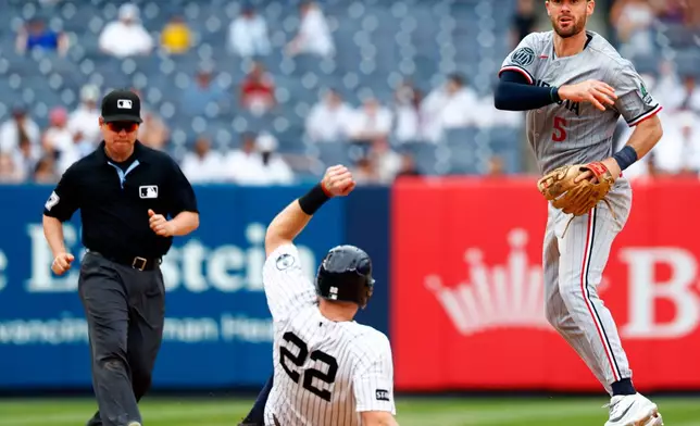 Minnesota Twins' center fielder Ryan Kreidler (5) makes the throw to first base to complete the double play. New York Yankees Ben Rice (22) and Jasson Domínguez were out on the play during the ninth inning of a baseball game, Sunday, July 5, 2026, in New York. (AP Photo/Noah K. Murray)