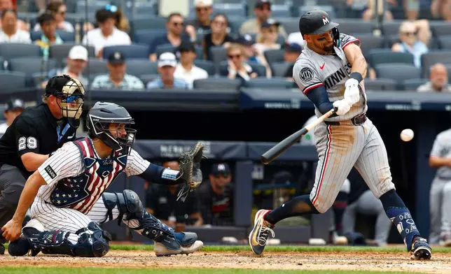 Minnesota Twins' Royce Lewis, right, hits an RBI single against the New York Yankees during the fifth inning of a baseball game, Sunday, July 5, 2026, in New York. (AP Photo/Noah K. Murray)