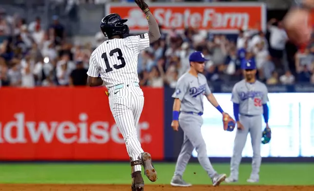 New York Yankees' Jazz Chisholm Jr. reacts running the base after hitting a home run against the Los Angeles Dodgers during the eighth inning of the second game of a baseball doubleheader, Sunday, July 19, 2026 in New York. (AP Photo/Noah K. Murray)