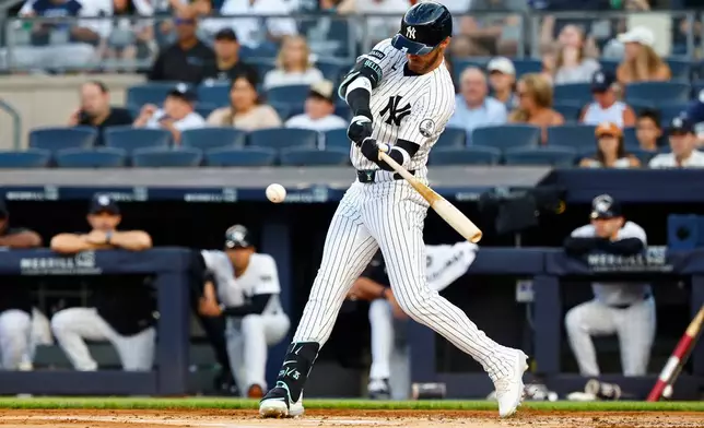New York Yankees' Cody Bellinger hits an RBI single against the Los Angeles Dodgers during the first inning of the second game of a baseball double header, Sunday, July 19, 2026 in New York. (AP Photo/Noah K. Murray)