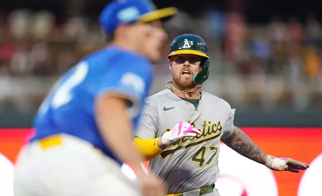 Athletics' Tommy White (47) races to third base before getting tagged out at home late during the fifth inning of a baseball game against the Minnesota Twins, Friday, July 24, 2026, in Minneapolis. (AP Photo/Ellen Schmidt)