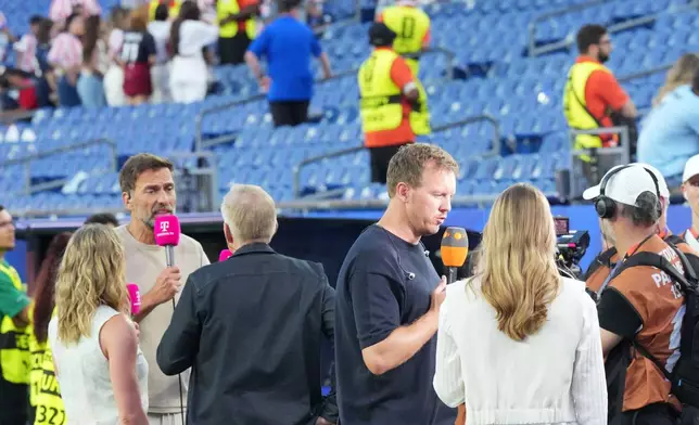Jurgen Klopp, left and Germany head coach Julian Nagelsmann give interviews after Germany's loss during the World Cup round of 32 soccer match between Germany and Paraguay in Foxborough, Mass., near Boston, Monday, June 29, 2026. (AP Photo/Martin Meissner)