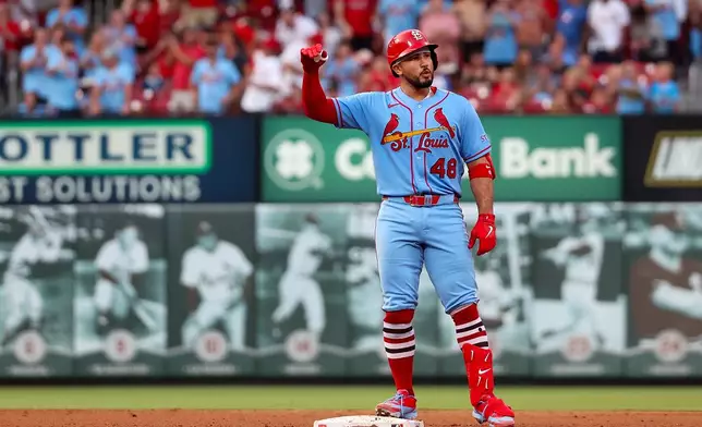 St. Louis Cardinals' Iván Herrera gestures from second base after hitting a two-RBI double during the sixth inning of a baseball game against the Cincinnati Reds Saturday, July 25, 2026, in St. Louis. (AP Photo/Scott Kane)