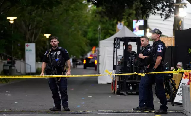 Police respond to a shooting at Seattle Center during the Bite of Seattle food festival Sunday, July 26, 2026, in Seattle, Wash. (AP Photo/Lindsey Wasson)