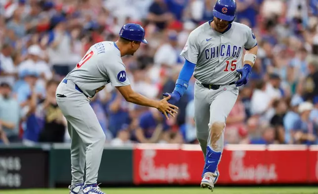 Chicago Cubs' Carson Kelly, right, celebrates his home run against Cincinnati Reds' Nick Lodolo during the sixth inning of a baseball game, Saturday, July 11, 2026, in Cincinnati. (AP Photo/Jay LaPrete)