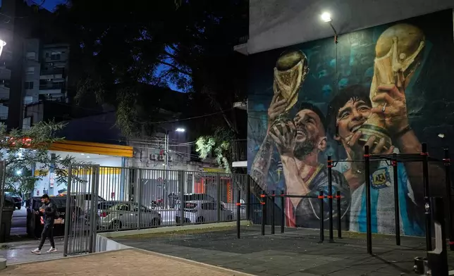 A mural of Argentine soccer players Lionel Messi and Diego Maradona decorate a wall in Buenos Aires, Argentina, early Thursday, July 30, 2026. (AP Photo/Natacha Pisarenko)
