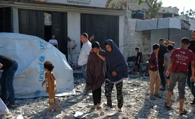 Residents inspect the site of an Israeli airstrike in Gaza city, Saturday, July 18, 2026. (AP Photo/Jehad Alshrafi)