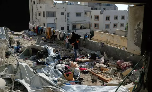 Residents inspect the site of an Israeli airstrike in Gaza city, Saturday, July 18, 2026. (AP Photo/Jehad Alshrafi)