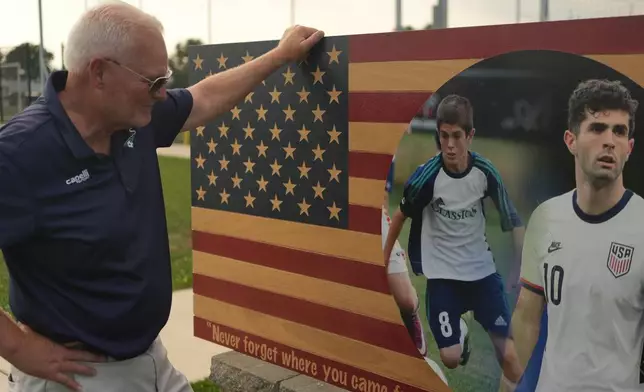Pennsylvania Classic co-founder and president, Doug Harris, looks at a banner of U.S. national team soccer player, Christian Pulisic, who was born in nearby Hershey, and honed his skills at the club in Manheim, Pa., on Monday, June 29, 2026. (AP Photo/Luis Andres Henao)