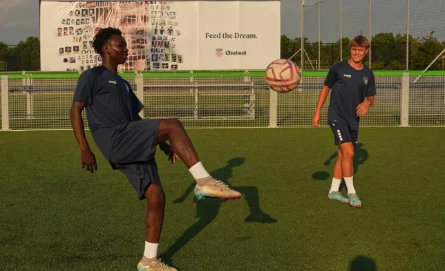 Pennsylvania Classic players Moussa Oumarou, left, and Liam Gustafson, right, juggle the ball before training at the club were U.S. national team soccer player, Christian Pulisic, honed his skills in Manheim, Pa., on Monday, June 29, 2026. (AP Photo/Luis Andres Henao)