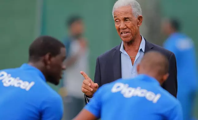 FILE - West Indies cricket great Garfield Sobers, right, chats with West Indies team members during a training session ahead of their second test cricket match against Sri Lanka in Colombo, Sri Lanka, Oct. 21, 2015. (AP Photo/Eranga Jayawardena, File)