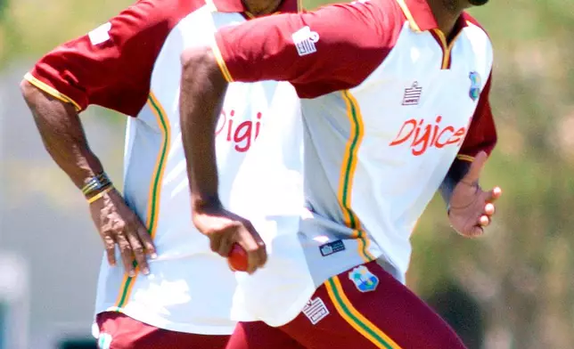 File - Under the watchful eyes of West Indies technical consultant Sir Garfield Sobers, left, West Indies fast bowler Cory Collymore bowls during a practice session at 3Ws Oval in Bridgetown, Barbados, March 26, 2005. (AP Photo/Chris Brandis, File)