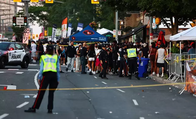 Police respond to an active shooter at the Salsa on St. Clair event in Toronto, Saturday, July 11, 2026. (Keito Newman/The Canadian Press via AP)