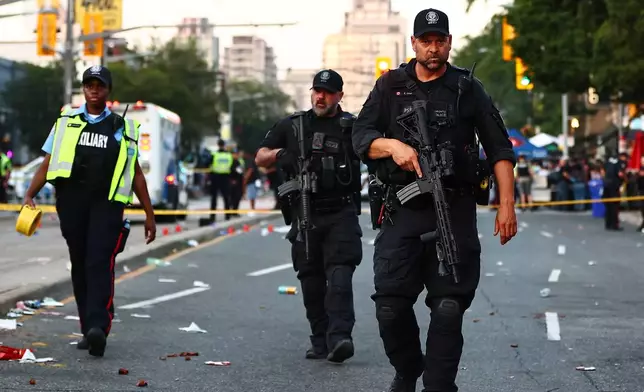 Police respond to an active shooter at the Salsa on St. Clair event in Toronto, Saturday, July 11, 2026. (Keito Newman/The Canadian Press via AP)