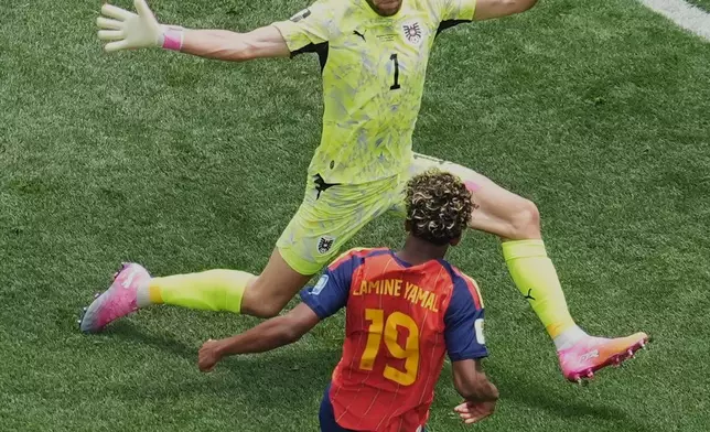 Austria goalkeeper Alexander Schlager, top, blocks a shot by Spain's Lamine Yamal during the World Cup round of 32 soccer match between Spain and Austria in Inglewood, Calif., near Los Angeles, Thursday, July 2, 2026. (AP Photo/Marcio J. Sanchez)