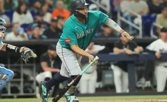 Seattle Mariners' Josh Naylor hits a single during the eighth inning of a baseball game against the Miami Marlins Tuesday, July 7, 2026, in Miami. (AP Photo/Marta Lavandier)