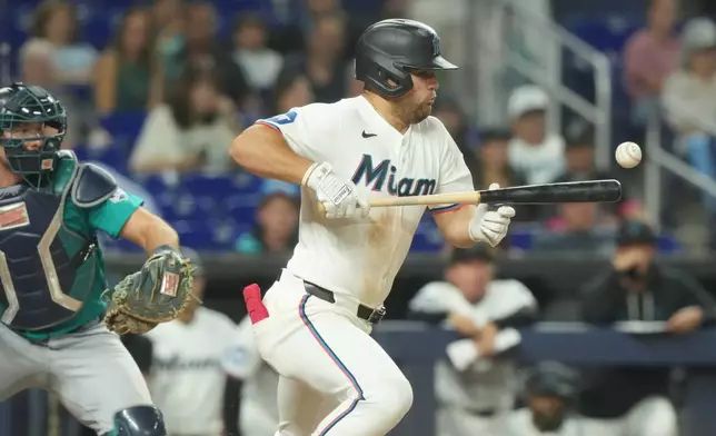 Miami Marlins' Jakob Marsee bunts the ball during the eighth inning of a baseball game against the Seattle Mariners Tuesday, July 7, 2026, in Miami. (AP Photo/Marta Lavandier)