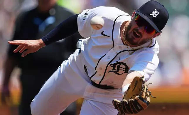 Detroit Tigers second baseman Zach McKinstry flips the ball to first base for an out on a Philadelphia Phillies' Bryce Harper ground ball during the third inning Sunday, July 12, 2026, in Detroit. (AP Photo/Paul Sancya)