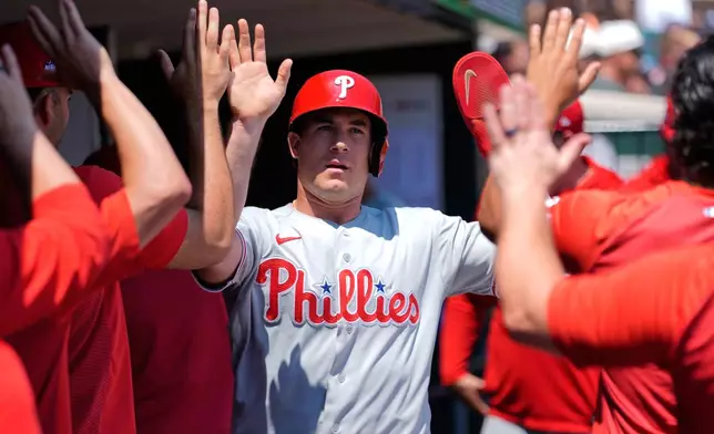 Philadelphia Phillies' J.T. Realmuto celebrates after scoring against the Detroit Tigers during the third inning Sunday, July 12, 2026, in Detroit. (AP Photo/Paul Sancya)