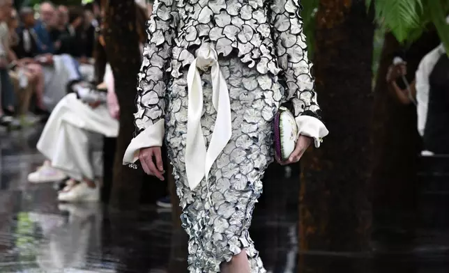 A model wears a creation as part of the Christian Dior Haute Couture Fall/Winter 2026-2027 Women's collection presented in Paris, Monday, July 6, 2026. (AP Photo/Emma Da Silva)