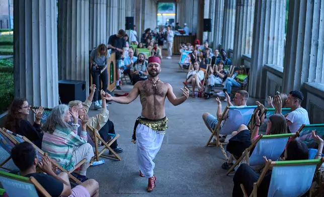 Haidar Darwish, a Syrian belly dancer with the Berlin-based LGBTQ collective Queens Against Borders, performs during an open-air show in Berlin, Germany, Sunday, July 26, 2026. (AP Photo/Ebrahim Noroozi)