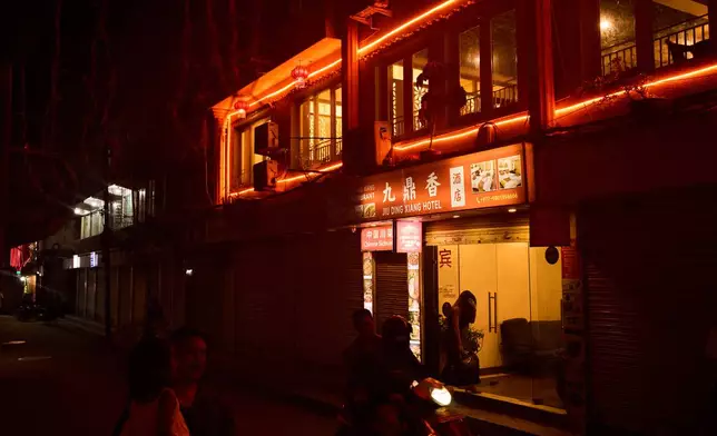 A person enters a hotel where many sex workers meet clients in Kathmandu, Nepal, Friday, May 22, 2026. (AP Photo/Bram Janssen)