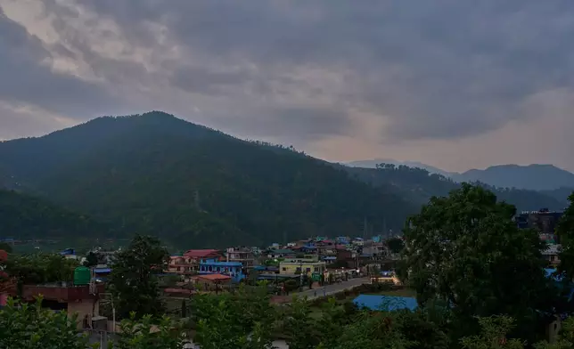 Colorful buildings sit along a main road in Hetauda, Nepal, Thursday, May 14, 2026. (AP Photo/Bram Janssen)