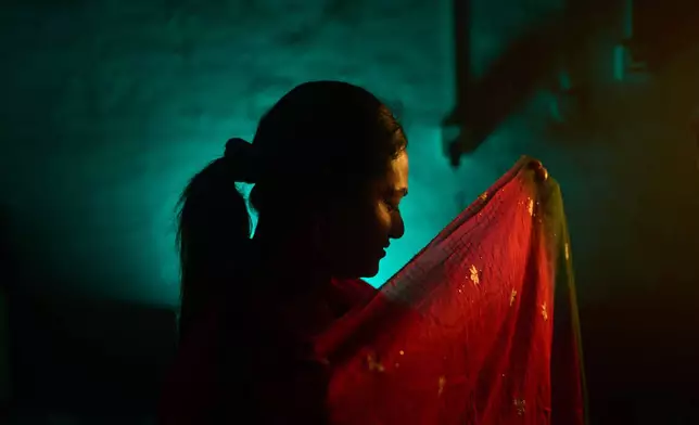 Sujata Chaudhary, who is transgender and a former aid worker who turned to sex work to survive after losing her job amid the U.S. foreign aid cuts, poses for a photo in Kathmandu, Nepal, Friday, May 22, 2026. (AP Photo/Bram Janssen)